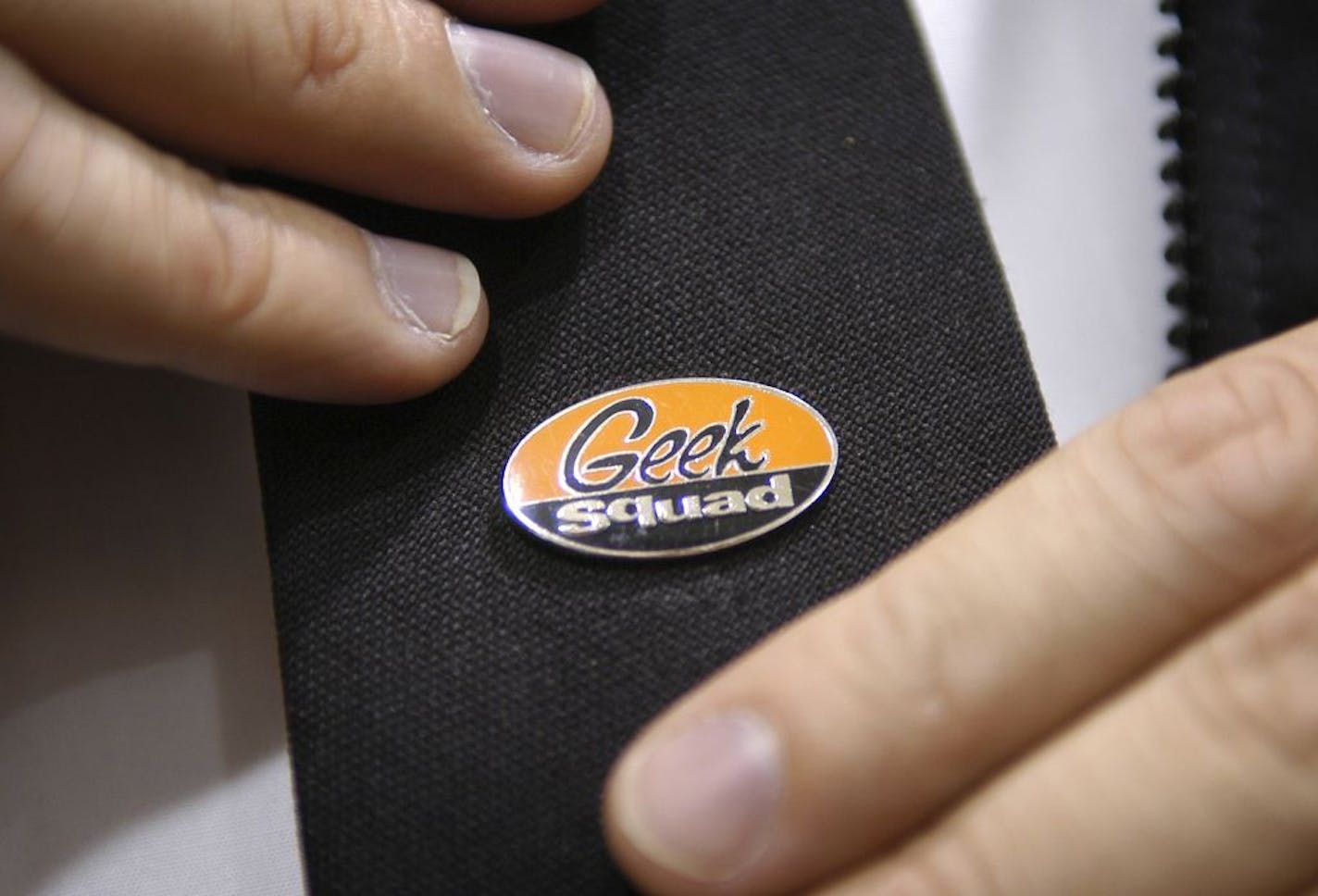 Geek Squad agents wear company tie pins as part of their uniform.