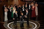 The cast and crew of "Oppenheimer" accept the award for best picture during the Oscars on Sunday, March 10, 2024, at the Dolby Theatre in Los Angeles.