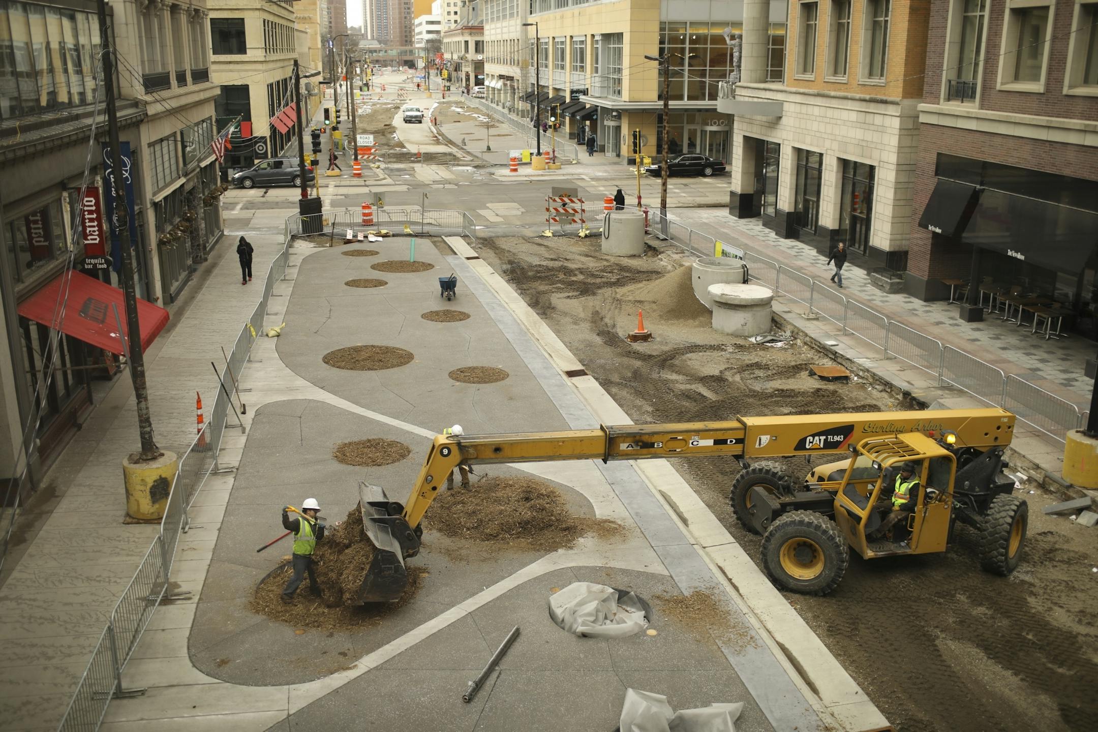 Jen Merth, field manager for Wetland Habitat Restorations, forked mulch into a bed Wednesday afternoon in the 900 block of the Nicollet Mall that will be planted with either an oak or birch tree in coming months.