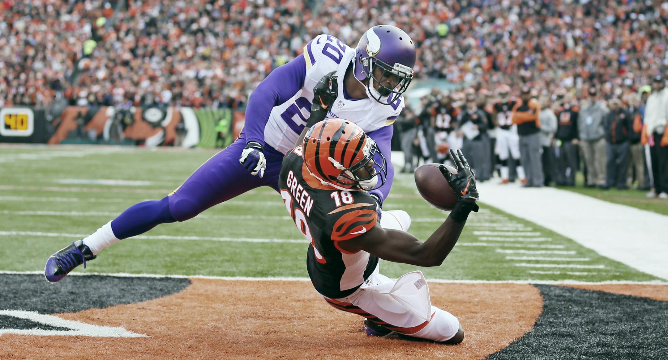 Cincinnati Bengals wide receiver A.J. Green (18) pulled down a 7 yard third quarter touchdown over Minnesota Vikings cornerback Chris Cook (20) during NFL action between the Minnesota Vikings and the Cincinnati Bengals at Paul Brown Field Sunday December 22, 2013 in Cincinnati, Ohio,