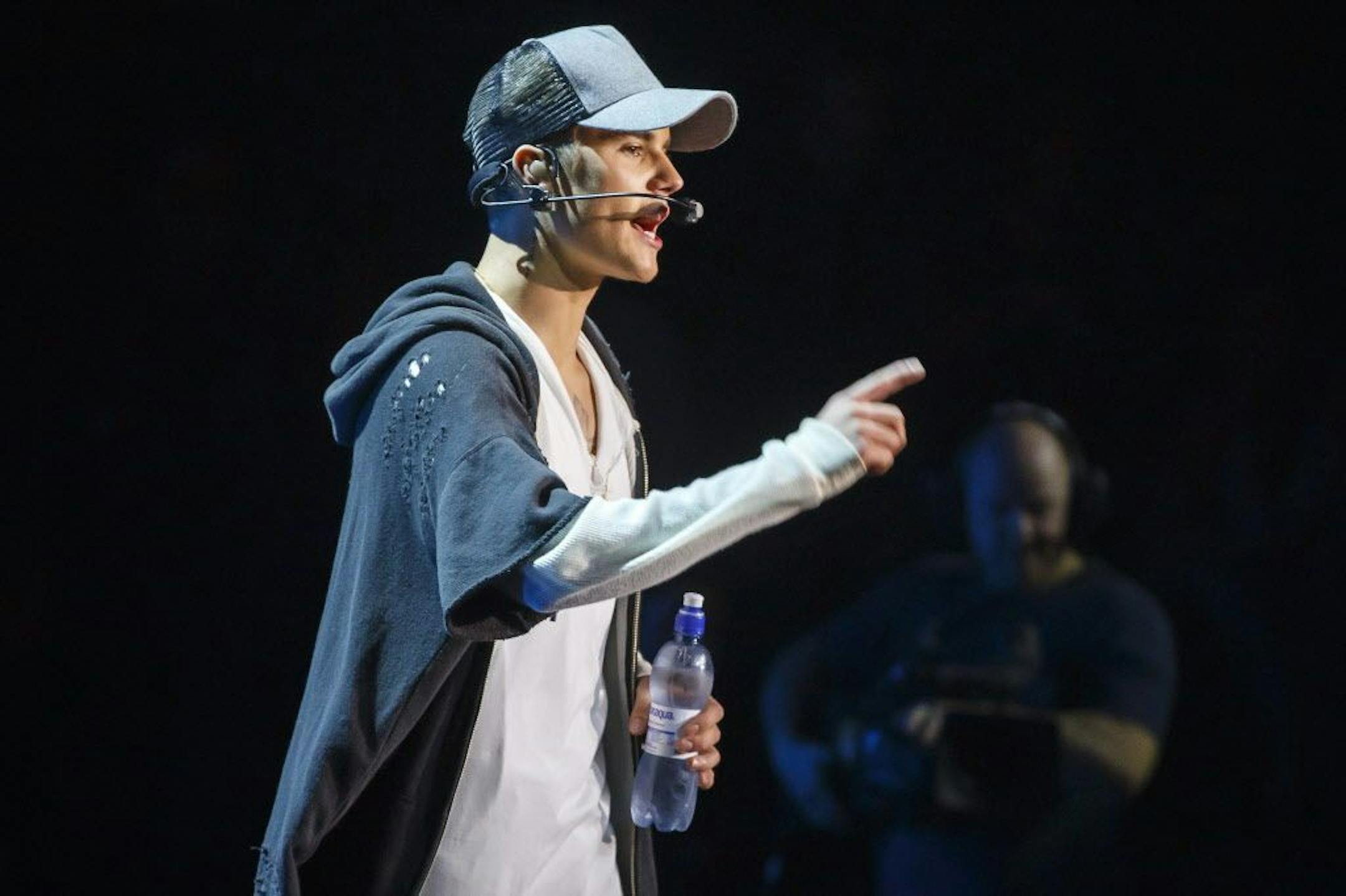 Singer Justin Bieber gestures as he stands on stage during a concert in Oslo, Thursday Oct. 29, 2015. Bieber says he stopped a concert in Oslo after one song Thursday because fans got in his way as he tried to wipe up liquid on stage.