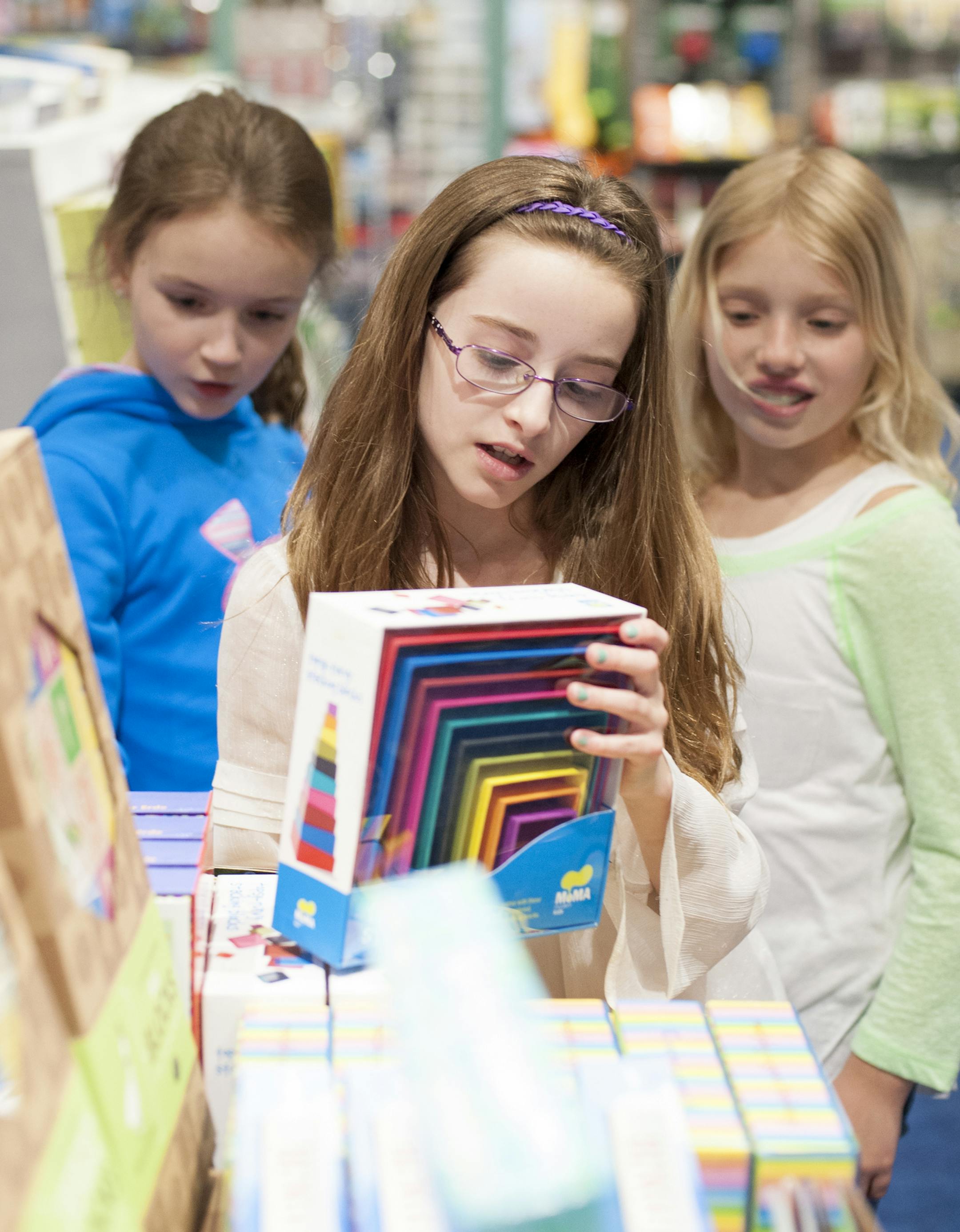 From left to right, Julia Grayson, 10, Carly Barcus, 9 and Elise Williams, 9 all shop in the Science Museum gift shop on April 8, 2015. ] Photo by Leslie Plesser ï Special to the Star Tribune