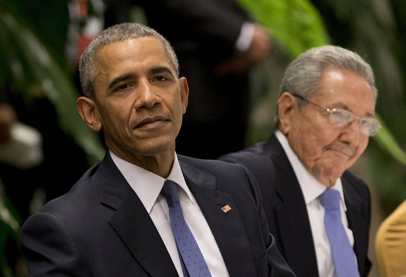 President Barack Obama, left, listens to a live band along with Cuba's President Raul Castro during a state dinner at the Palace of the Revolution in Havana, Cuba, Monday, March 21, 2016. Laying bare a half-century of tensions, Obama and Castro prodded each other Monday over human rights and the long-standing U.S. economic embargo during an joint news conference. (AP Photo/Rebecca Blackwell) ORG XMIT: MIN2016032212445896