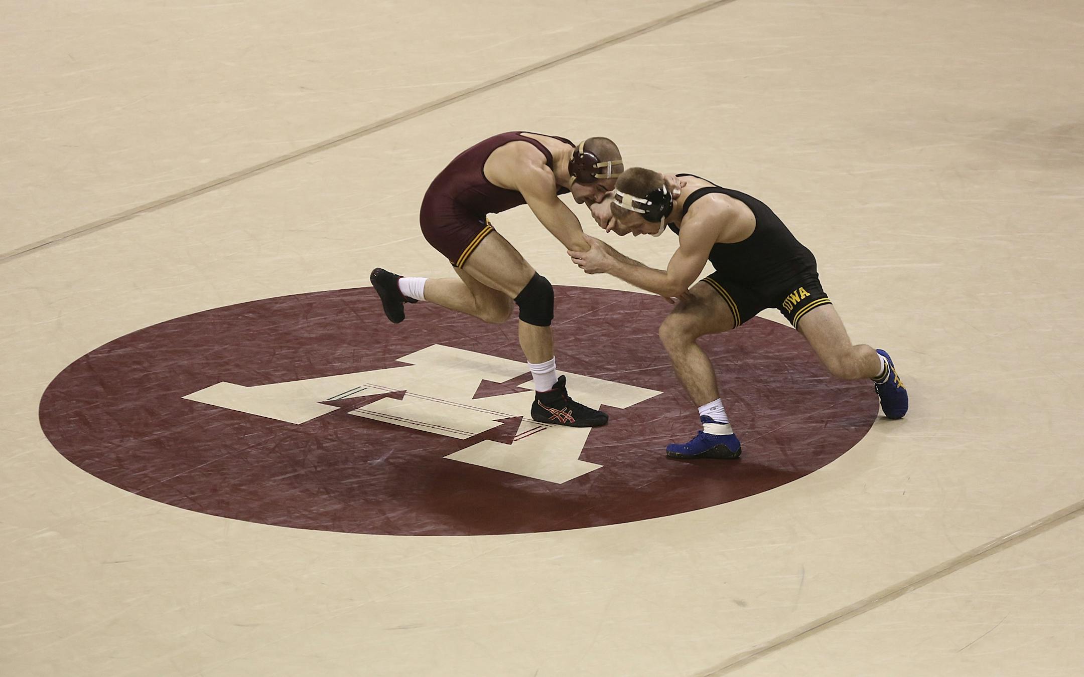 Gophers Cody Yohn and Iowa's Nick Moore wrestled in the middle of the mat in the 165 pound weight class at Williams Arena in Minneapolis, Min., Saturday , January 26, 2013.