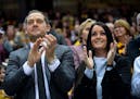 New Minnesota Golden Gophers football head coach P.J. Fleck and wife Heather Fleck clapped along during the Gophers fight song Saturday night at the e