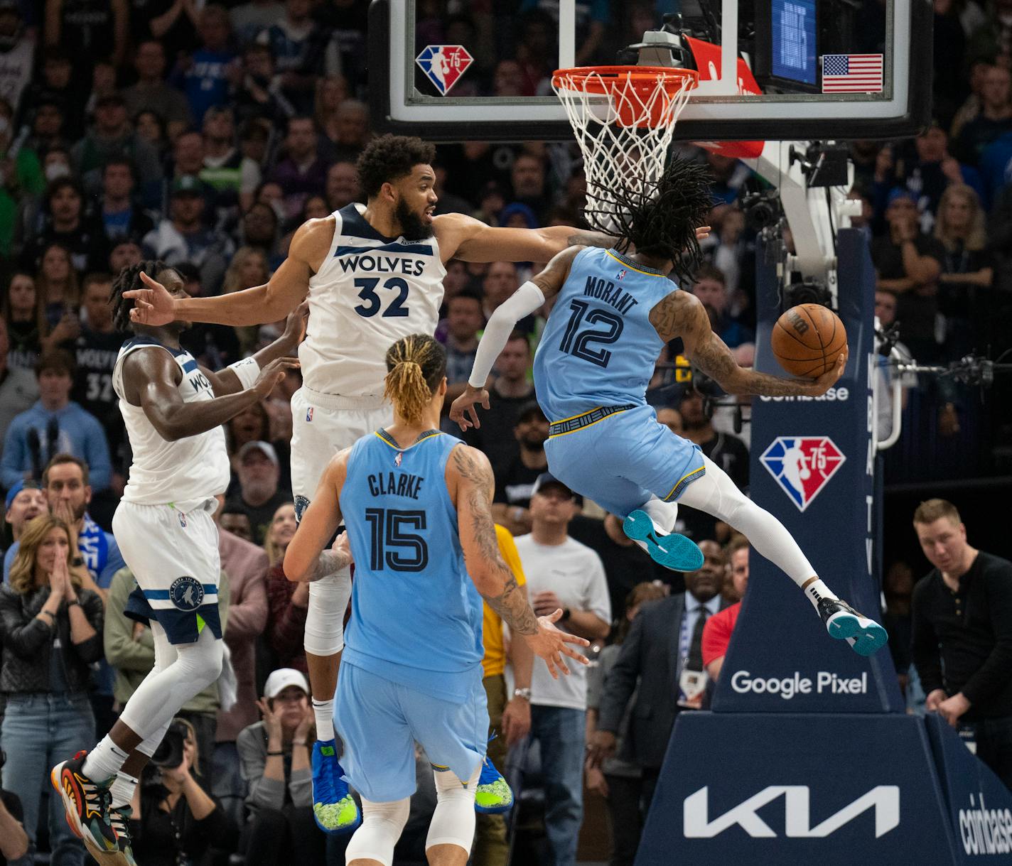 Minnesota Timberwolves center Karl-Anthony Towns (32) defended Memphis Grizzlies guard Ja Morant (12) as he drove to the net late in the fourth quarter Saturday night, April 23, 2022 at Target Center in Minneapolis. The Minnesota Timberwolves defeated the Memphis Grizzlies 119-118 in game 4 of their NBA first round playoff series. ] JEFF WHEELER • Jeff.Wheeler@startribune.com