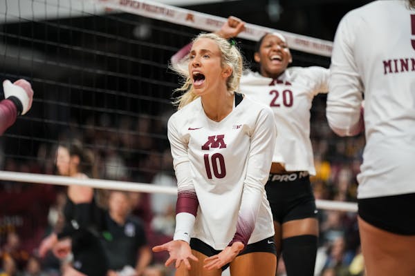 Elise McGhie (10) screamed while Arica Davis (20) pumped her fist during the Gophers’ come-from-behind victory over Northwestern on Sunday.
