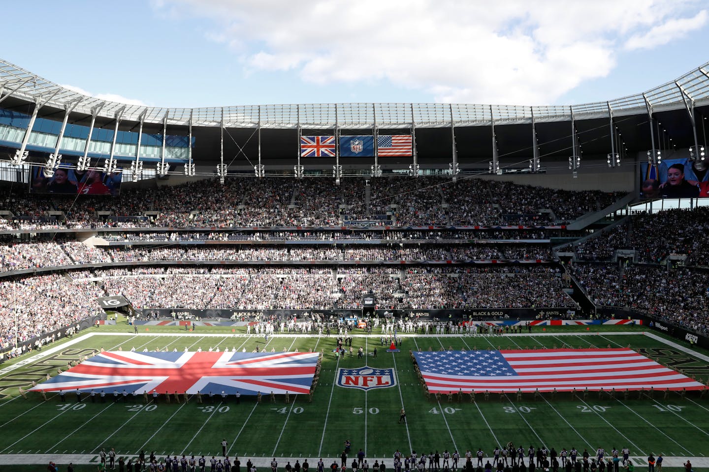 The Union and United States flags are displayed on the field before an NFL football game between the New Orleans Saints and the Minnesota Vikings at Tottenham Hotspur Stadium, Sunday, Oct. 2, 2022, in London. The Minnesota Vikings won 28-25. (AP Photo/Steve Luciano)