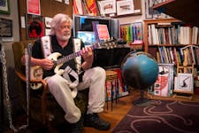 Dave Thune, a resident of Irvine Park, former City Council member and owner of Thune Studio on West 7th Street, plays guitar in his studio Thursday in