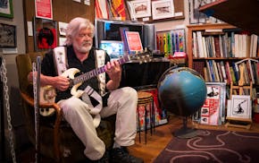 Dave Thune, a resident of Irvine Park, former City Council member and owner of Thune Studio on West 7th Street, plays guitar in his studio Thursday in