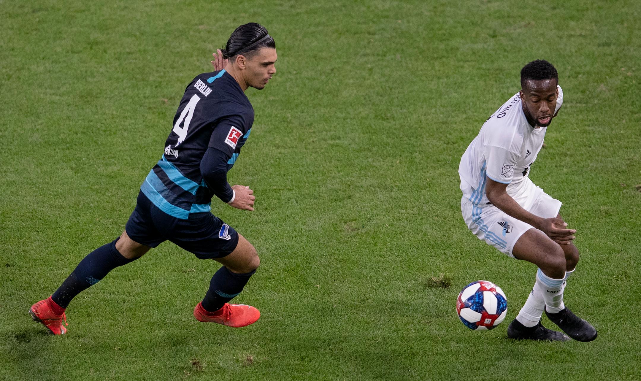 The Loons' Kevin Molino and Karim Rekik of Hertha Berlin fought for the ball in the first half.