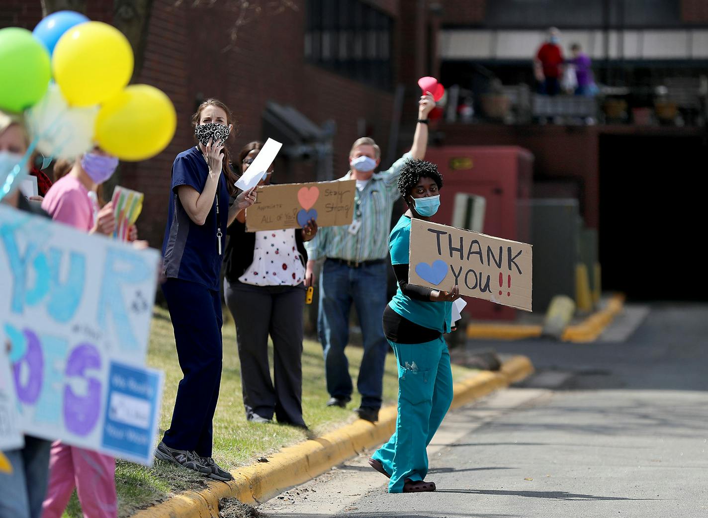 Kortoe Mikely, a nursing aide, held up a sign to thank supporters who gathered outside St. Therese of New Hope on Friday.