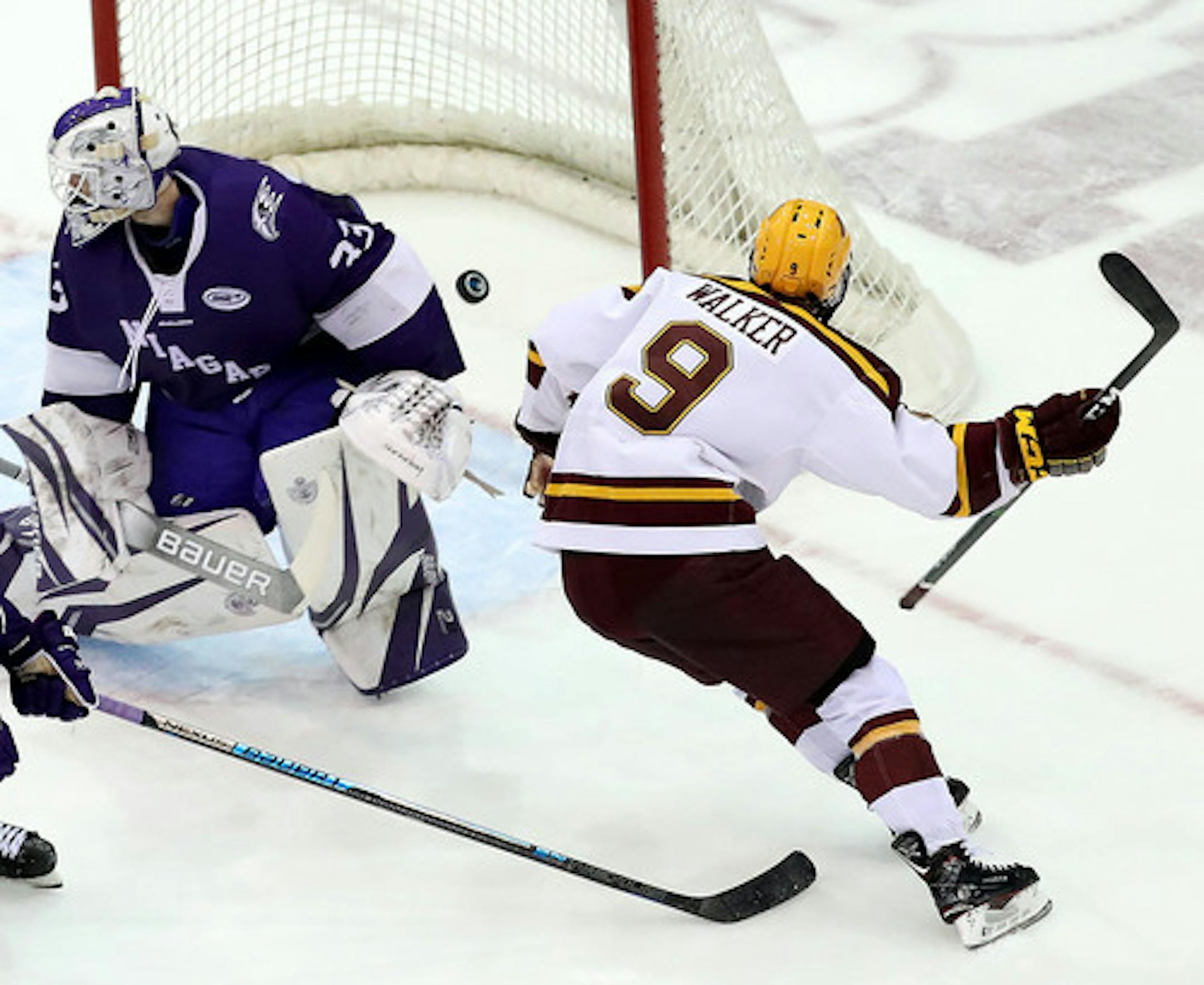 The University of Minnesota's Sammy Walker (9) got a shot past Niagara University goalie Brian Wilson (33) in overtime for the 3-2 game winner Friday, Oct. 18, 2019, at 3M Arena at Mariucci in Minneapolis, MN.]