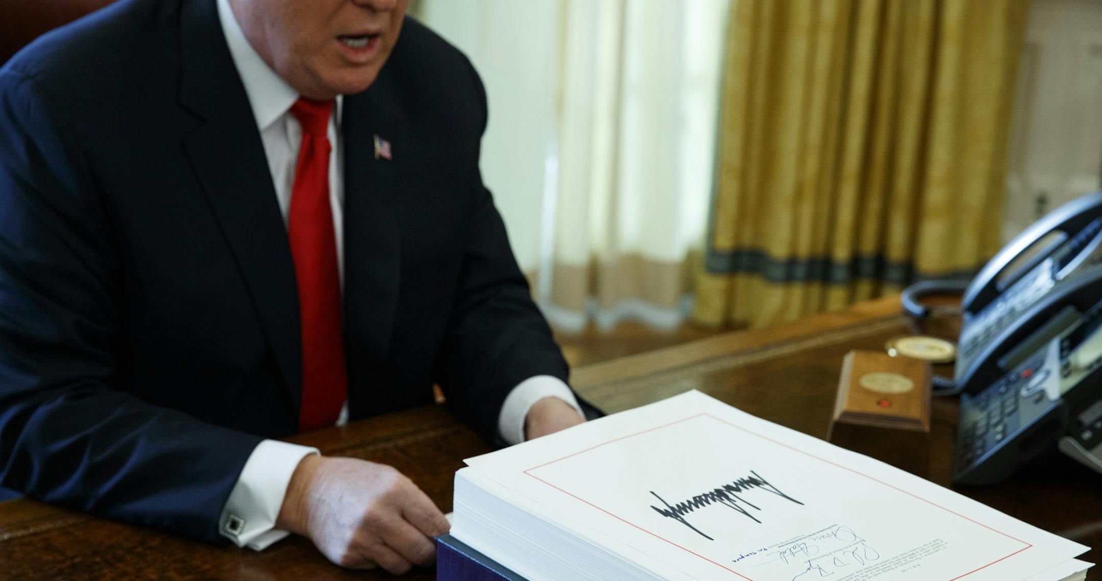 FILE- In this Dec. 22, 2017, file photo President Donald Trump speaks with reporters after signing the tax bill and continuing resolution to fund the government in the Oval Office of the White House in Washington. Millions of small business owners and their tax advisers will be in uncharted waters as they tackle 2018 returns, a new deduction that can exempt one-fifth of owners’ business income but that is complex and confusing. (AP Photo/Evan Vucci, File) ORG XMIT: NYBZ358