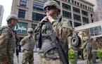 Members of the Minnesota National Guard stood at S. 7th Street and Nicollet Mall, Aug. 27, 2020, in Minneapolis, as community members and business own
