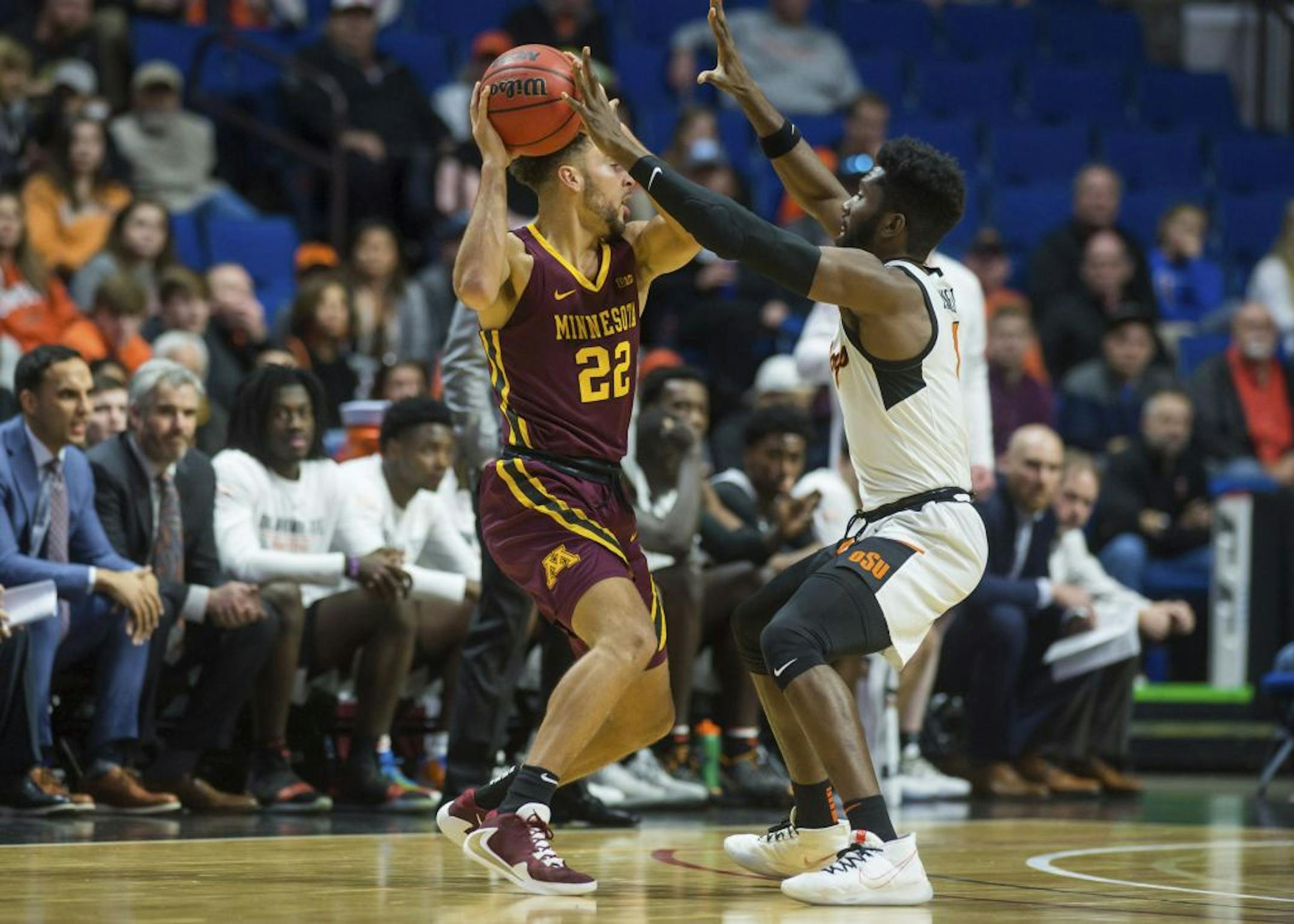 Oklahoma State guard Jonathan Laurent, right, guards against Minnesota guard Gabe Kalscheur during an NCAA college basketball game Saturday, Dec. 21, 2019, in Tulsa, Okla.