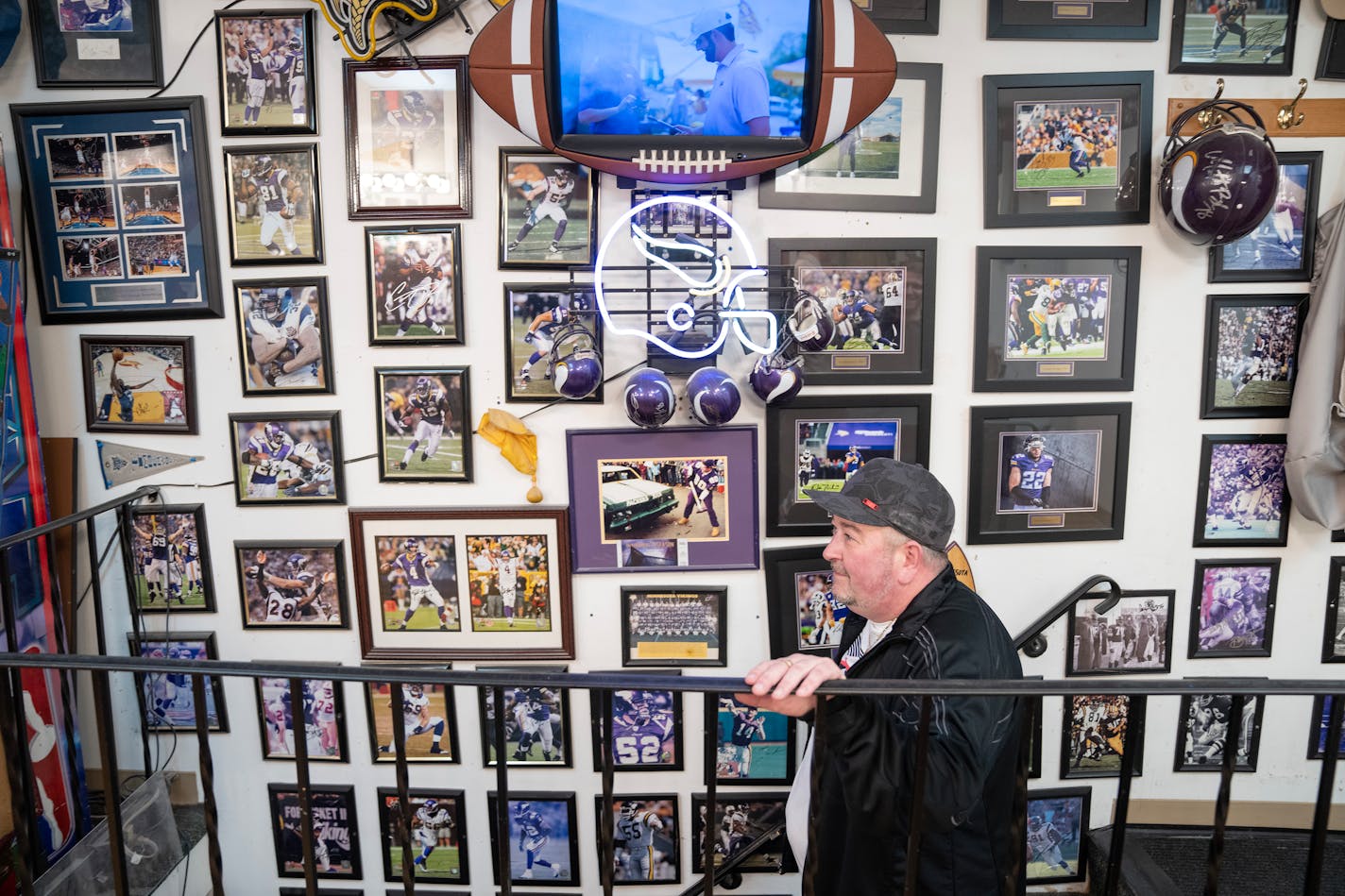 Dennis Manning walks down the stairs past his dozens of autographed photos on his wall Tuesday, Nov. 07, 2023, at Sportsmen's Barbers in Columbia Heights, Minn. The barbershop is being forced to vacate after 22 years with the landlord not renewing the lease and preparing to sell it to a music school. ]