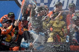 Driver Martin Truex Jr. (19) celebrated with his crew after winning the NASCAR Cup Series race Monday at Dover International Speedway in Dover, Del.