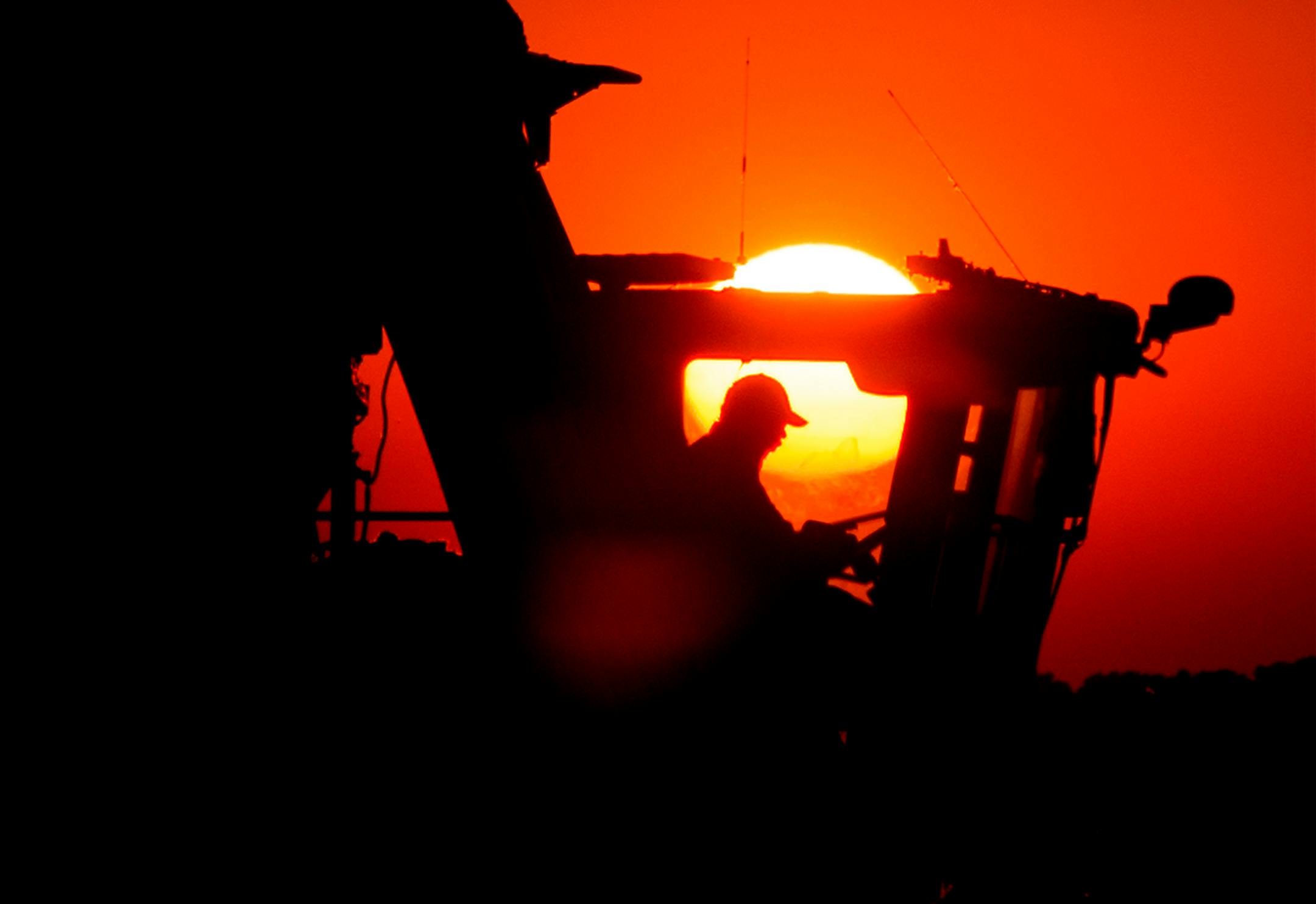 A John Deere 7760 cotton picker harvests cotton as the sun sets at Condrey Farms in East Carroll Parish, Louisiana, U.S., on Thursday, Oct. 10, 2013. Parts of the Mississippi Delta region will get as much as 0.5 inch (12.7 mm) of rain in the next 10 days, below the normal level of 1 inch to 1.5 inches. Photographer: Ty Wright/Bloomberg