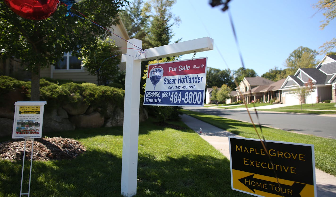 Signs point out an open house. ] (KYNDELL HARKNESS/STAR TRIBUNE) kyndell.harkness@startribune.com Open house in Maple Grove Min., Friday, August, 5, 2014.