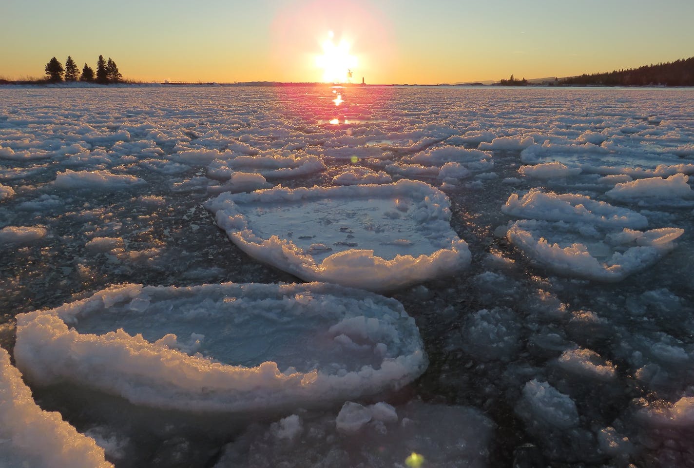 These "pancake ice" discs are formed by floating chunks colliding in Grand Marais' harbor.