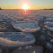 These "pancake ice" discs are formed by floating chunks colliding in Grand Marais' harbor.