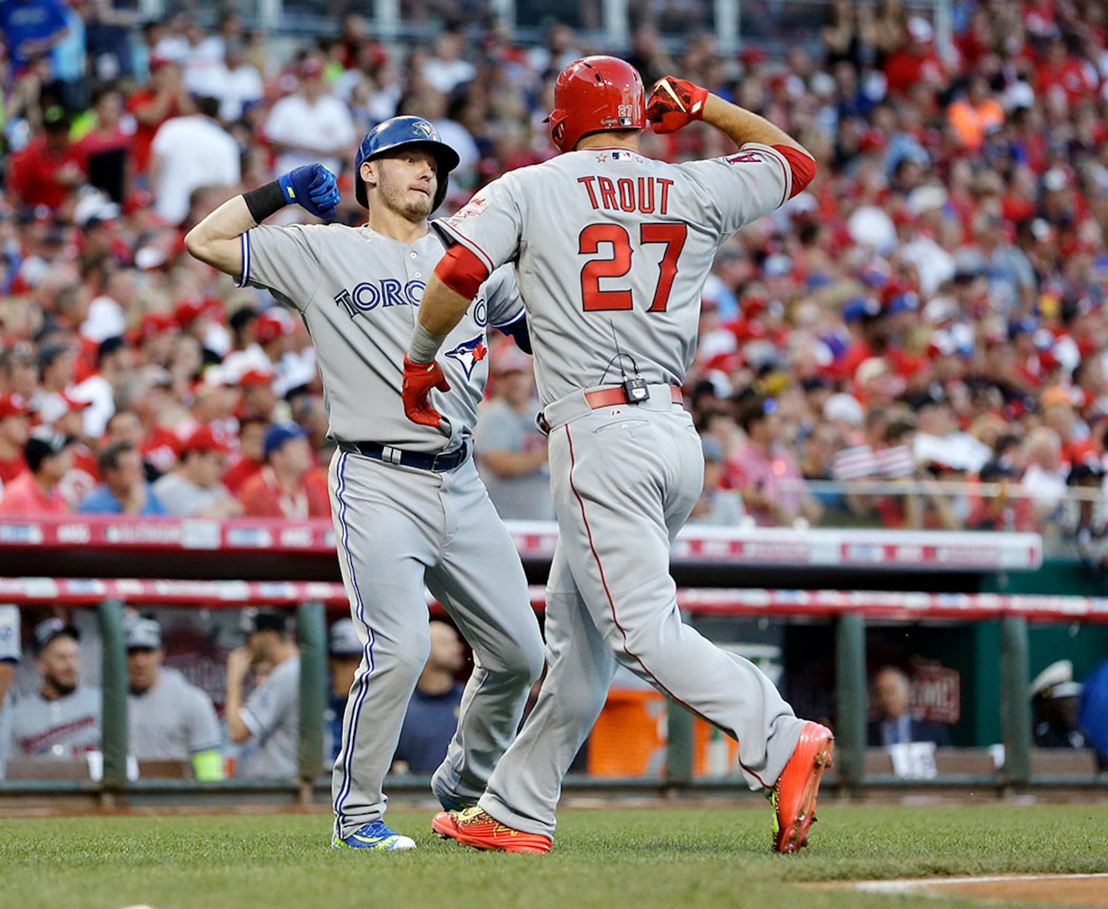 American League's Mike Trout, of the Los Angeles Angels, celebrates with American League's Josh Donaldson, of the Toronto Blue Jays, after Trout hit a lead off home run during the first inning of the MLB All-Star baseball game, Tuesday, July 14, 2015, in Cincinnati.