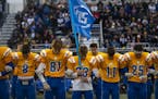 Sophomores on the Esko High School football team linked arms and bowed their heads in a moment of silence to honor Jackson Pfister, who was also a sop