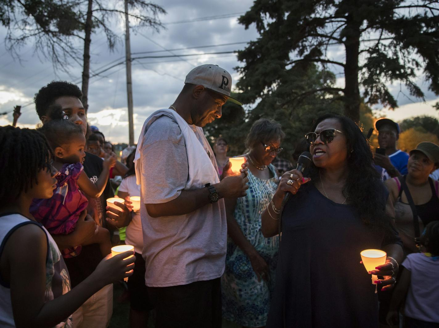 At right, mother of Philando Castile, Valerie Castile, spoke during a candlelight vigil at the scene of where Philando was shot by Officer Jeronimo Yanez a year ago that day in Falcon Heights, Minn., on July 6, 2017. The scene has become a memorial to Castile. Also pictured is Castile's friend John Thompson, center, and cousin Isaiah Johnson holding his niece London Amor. ] RENEE JONES SCHNEIDER &#x2022; renee.jones@startribune.com