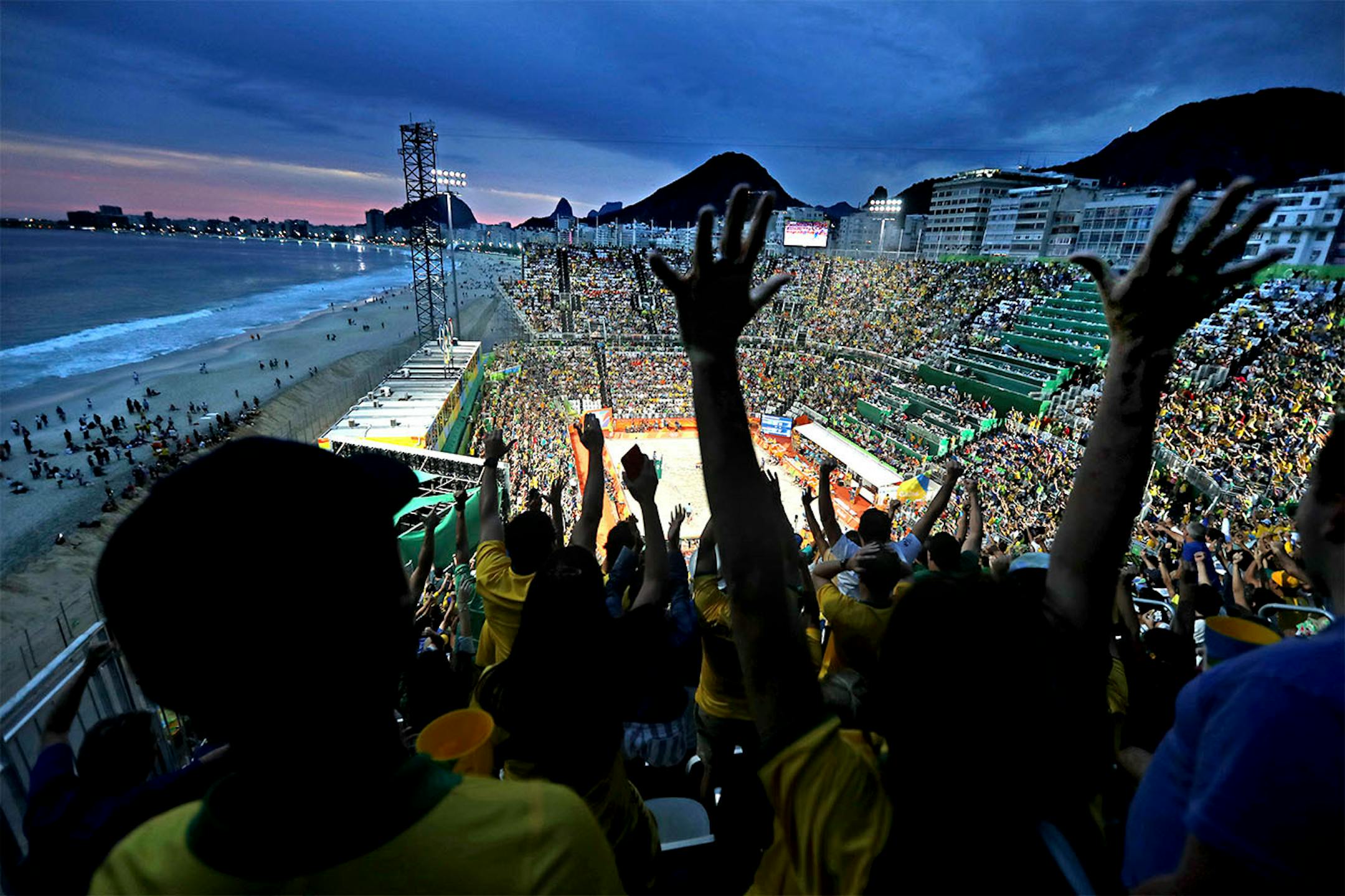 The beach volleyball venue is the centerpiece of the Rio games, situated right on Copacabana Beach, it attracts large crowds both inside and on the beach (left) Tuesday night was a big night for Brazil with two semifinal matches, women and men.