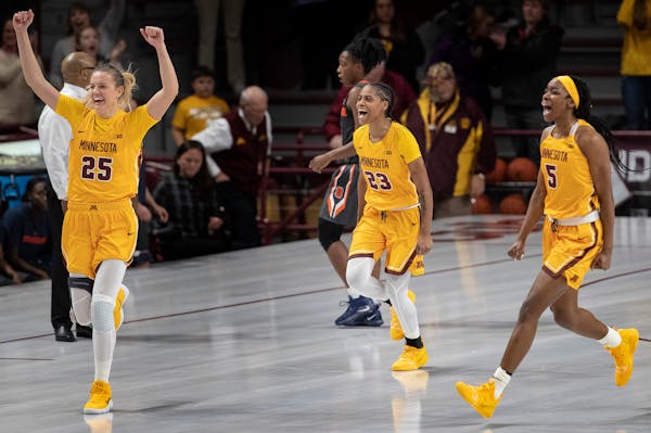 The Gophers' Taiye Bello (5) celebrate after beating Syracuse 72-68 on Thursday