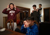 Quan Do, his brother Quang, Matvii Suminov, and Theo Krieger, 5, from left, visited after dinner in their on-campus apartment January 16, 2024 in Mend