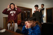 Quan Do, his brother Quang, Matvii Suminov, and Theo Krieger, 5, from left, visited after dinner in their on-campus apartment January 16, 2024 in Mend