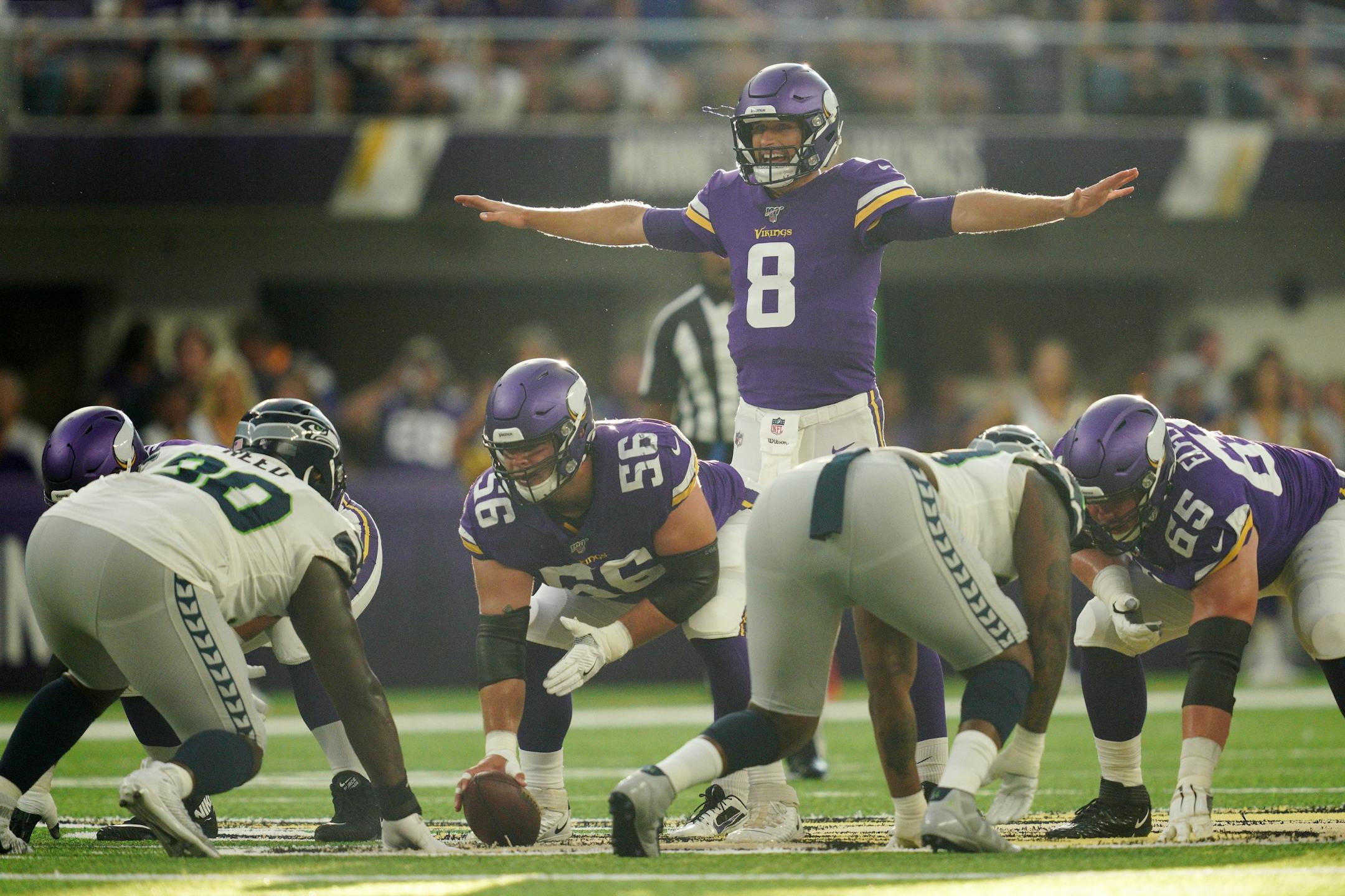 Minnesota Vikings quarterback Kirk Cousins (8) called a play on the line in the first half.