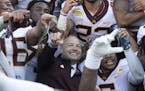 Minnesota Gophers head coach PJ Fleck celebrated with his players during a team photo following their victory against the Auburn Tigers. ] Aaron Lavin