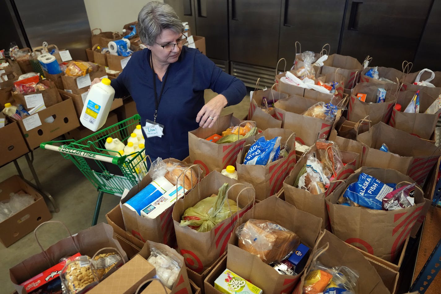 Volunteer Lisa Polzin helps pack more than 40 boxes of groceries to be delivered to area families in need of food assistance Tuesday, Jan. 16, 2024 at Bountiful Basket Food Shelf in Chaska, Minn.    ] ANTHONY SOUFFLE • anthony.souffle@startribune.com