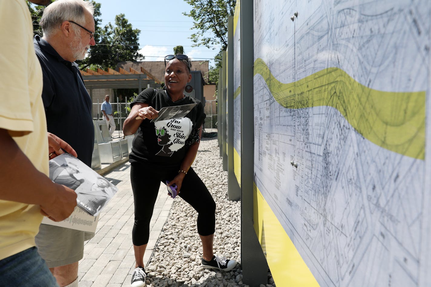 In 2018, Frances, right, and Jeremiah Ellis, left, talked with Greg Finzell as they looked at a board explaining how the construction of I-94 destroyed the Rondo neighborhood of St. Paul.