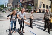 Sophie Konewko and Megan Albers decided to take two Bird scooters for a ride through downtown Minneapolis after lunch. They joked with two Hennepin Co