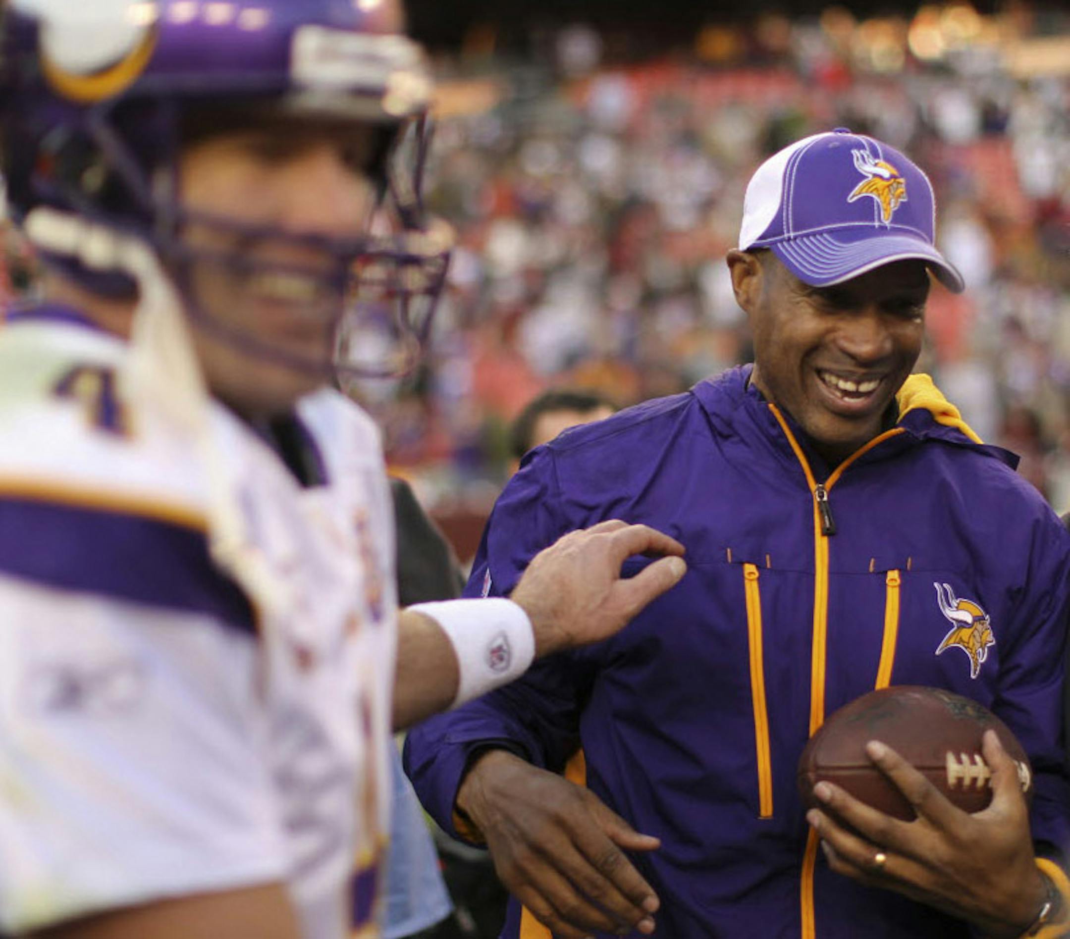Vikings interim head coach Leslie Frazier grinned and bore the game ball after quarterback Brett Favre presented it to him once the Vikings had beaten Washington for Frazier's first NFL victory.