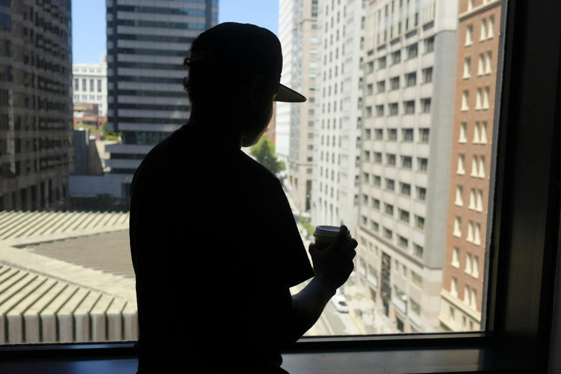 In this photo taken Friday, June 22, 2018, an 18-year-old Honduran who said he suffered abuse inside a Virginia immigration detention facility poses in front of a window in San Francisco. The teen's experience echoes abuse claims by other children whose accounts are included in a federal civil rights lawsuit charging that guards at the Shenandoah Valley Juvenile Center in Staunton, Virginia, beat them, locked them up for long periods in solitary confinement and left them nude and shivering in co