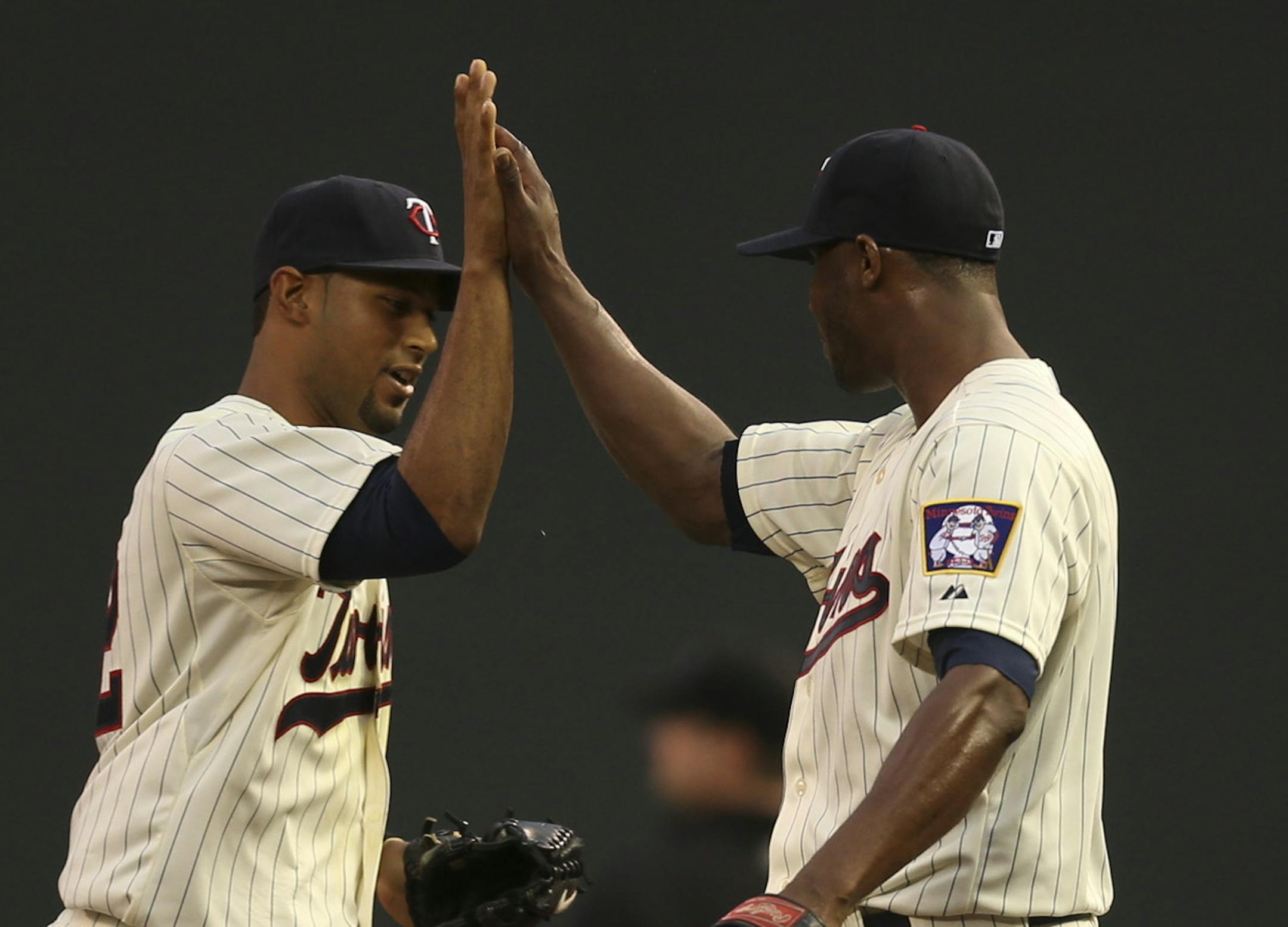 The Minnesota Twins began a home stand against the National League Milwaukee Brewers Wednesday night, May 29, 2013, at Target Field in Minneapolis. Aaron Hicks of the Twins was high fived by pitcher Samuel Deduno after he made a diving catch of a line drive to center by the Brewers' Rickie Weeks, right, to make the out and end the fouth inning. ] JEFF WHEELER ‚Ä¢ jeff.wheeler@startribune.com