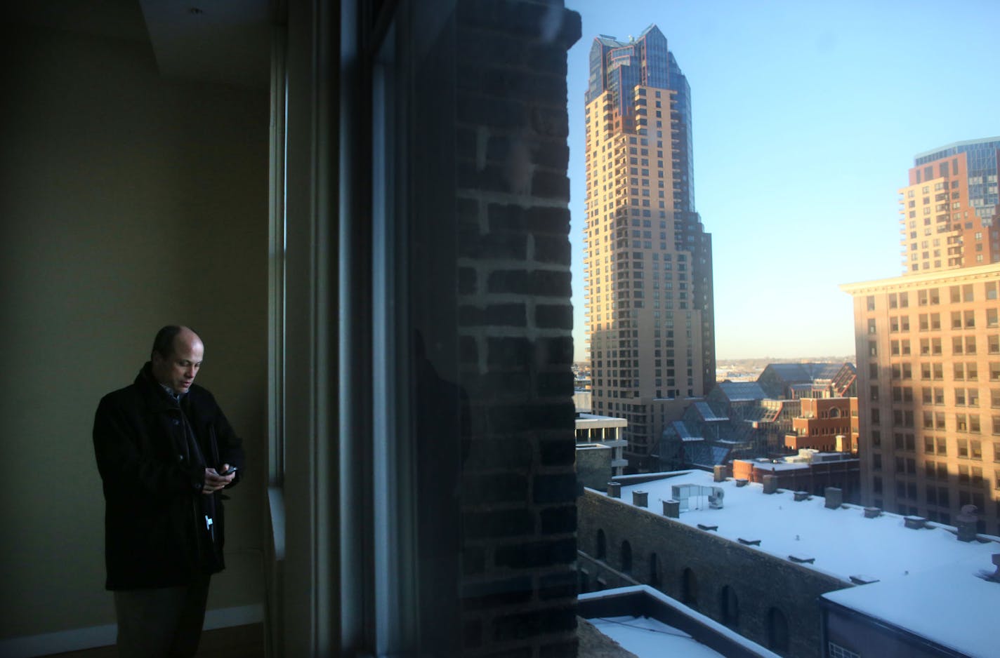 Mike Zipkpo, of Zipko Strategy, looked at his phone as he talked about the view from this two bedroom in one of the model apartments in Pioneer Building in St Paul Wednesday, January 8, 2014. ] (KYNDELL HARKNESS/STAR TRIBUNE) kyndell.harkness@startribune.com