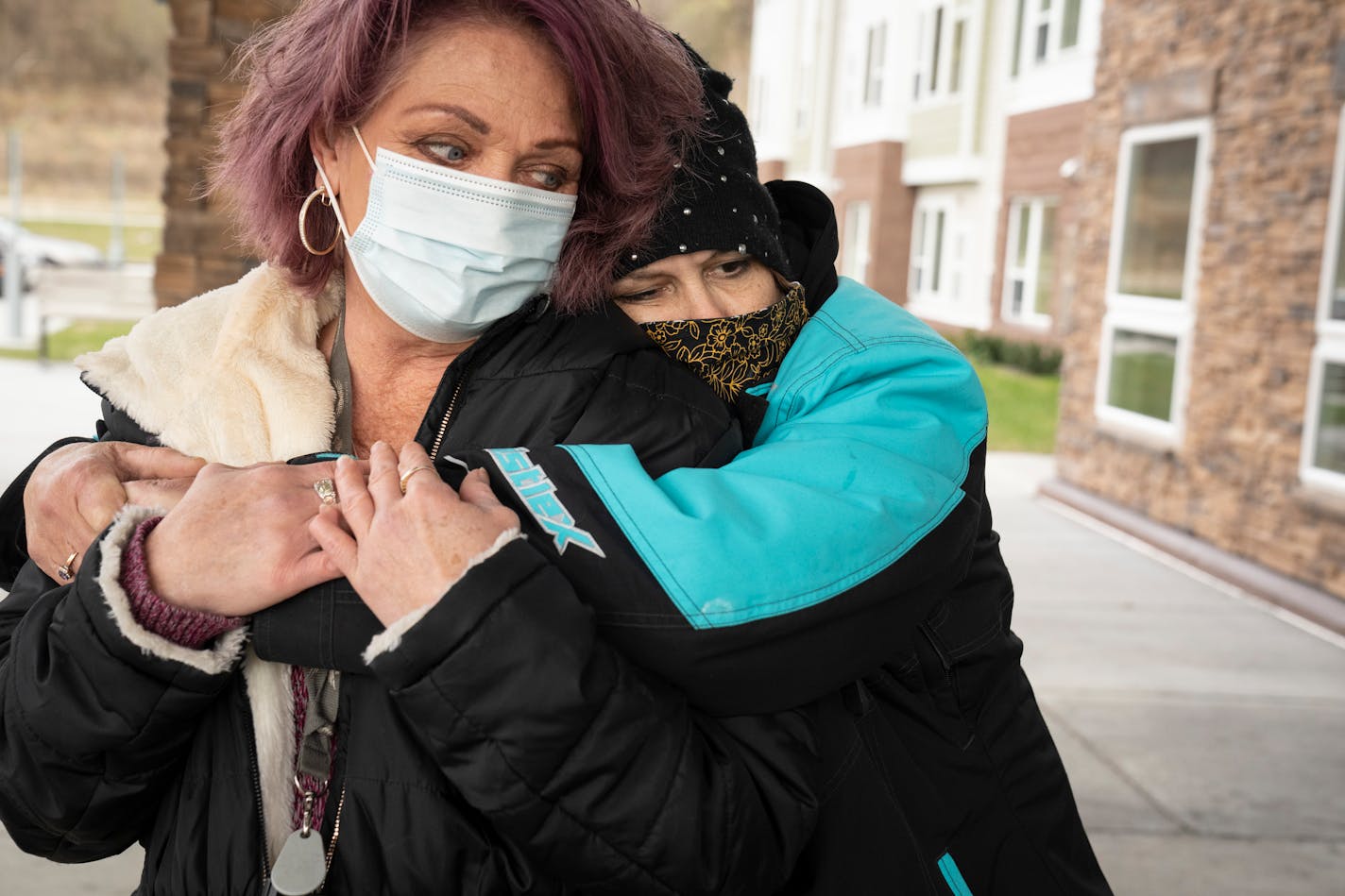 Laurie Eastwood hugs Wanda Grady, left, outside Wings of Newport apartments on Friday, Nov. 19, 2021, in Newport, Minn. They were recently told they have to move by Nov. 30 and have found no other housing.