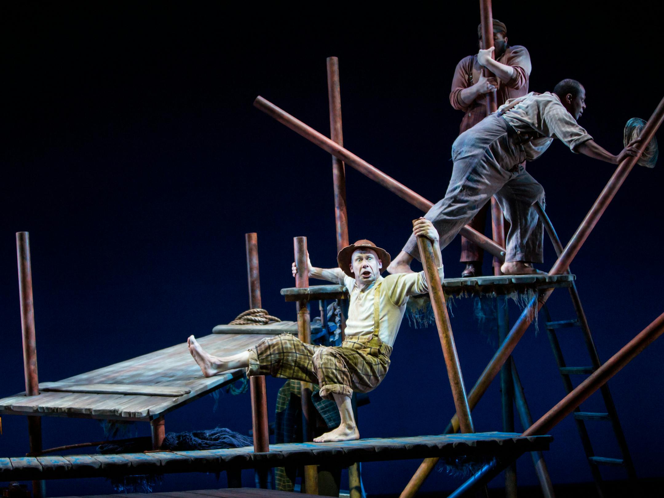 Dean Holt, center, is “Huck Finn” at Children’s Theatre.