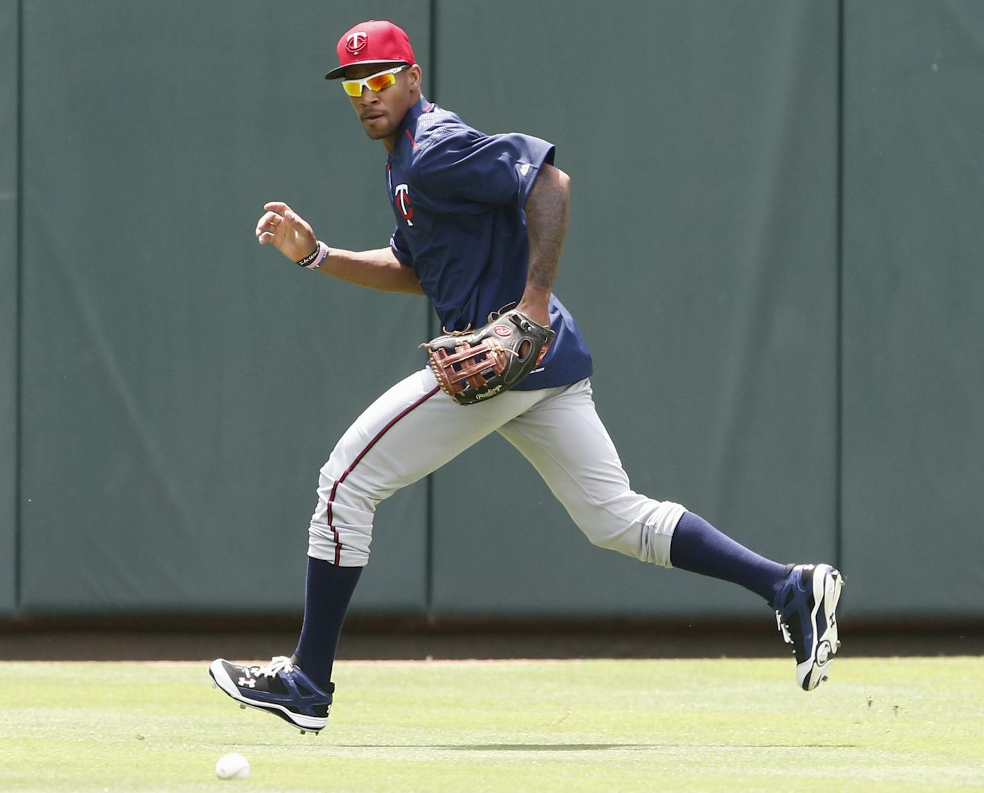 Minnesota Twins' Byron Buxton chases a ball during warmups before a baseball game against the Texas Rangers, Sunday, June 14, 2015, in Arlington, Texas. (AP Photo/Jim Cowsert)