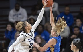 Minnetonka’s Aaliyah Crump blocks the shot of St. Michael-Albertville’s Cail Jahnke during the Class 4A semifinals