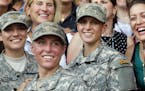 U.S. Army First Lt. Shaye Haver, center, and Capt. Kristen Griest, right, pose for photos with other female West Point alumni after an Army Ranger sch