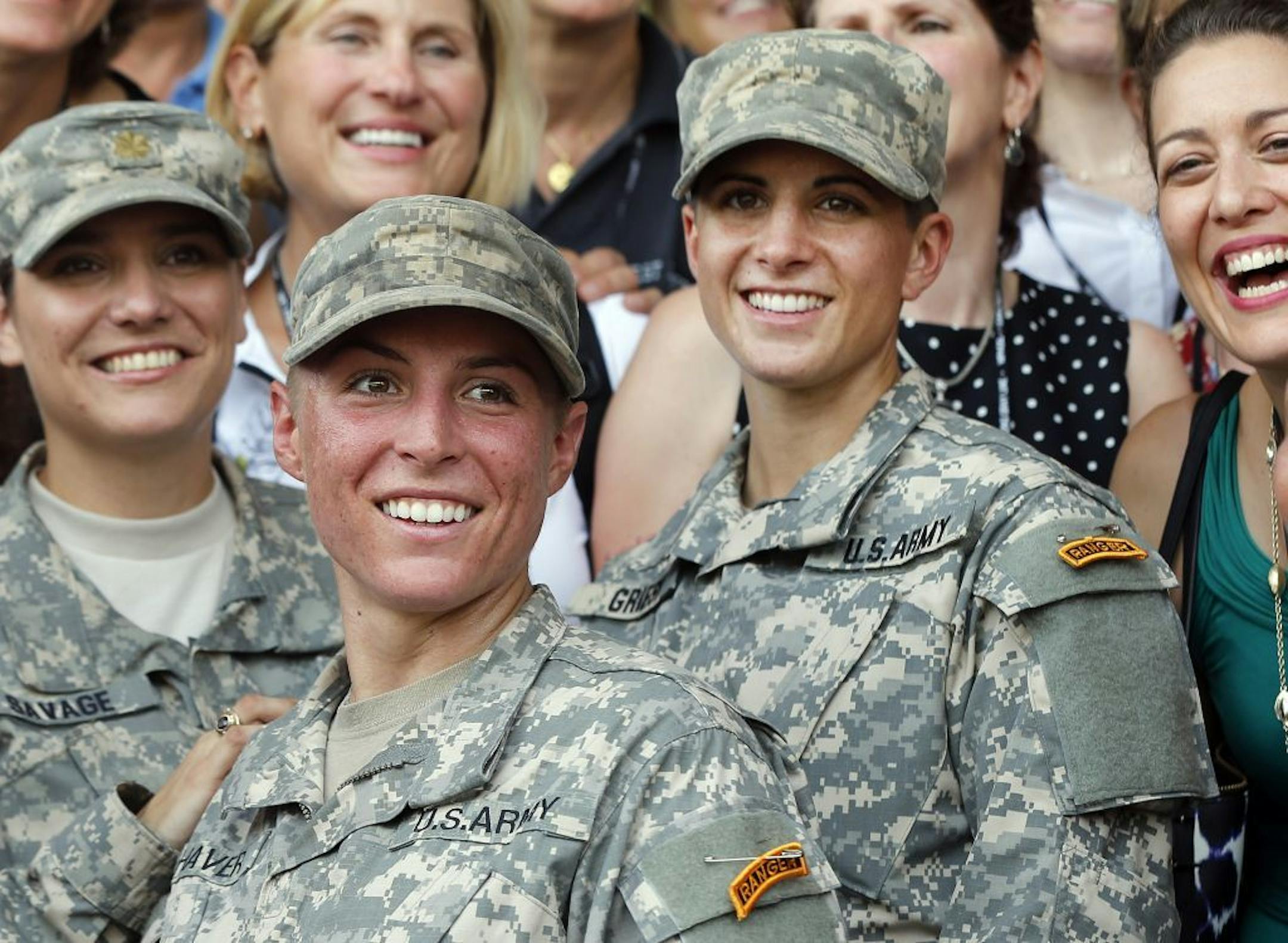 U.S. Army First Lt. Shaye Haver, center, and Capt. Kristen Griest, right, pose for photos with other female West Point alumni after an Army Ranger school graduation ceremony, Friday, Aug. 21, 2015, at Fort Benning, Ga. Haver and Griest became the first female graduates of the Army's rigorous Ranger School, putting a spotlight on the debate over women in combat.