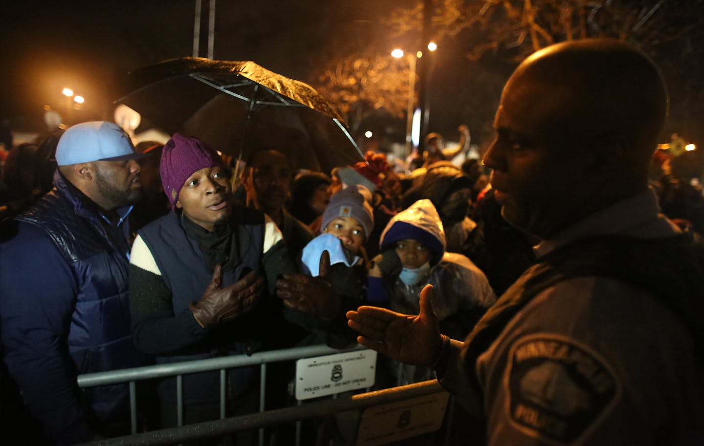 Angry community members loudly questioned a police officer who came out to talk about police actions in north Minneapolis on Wednesday..