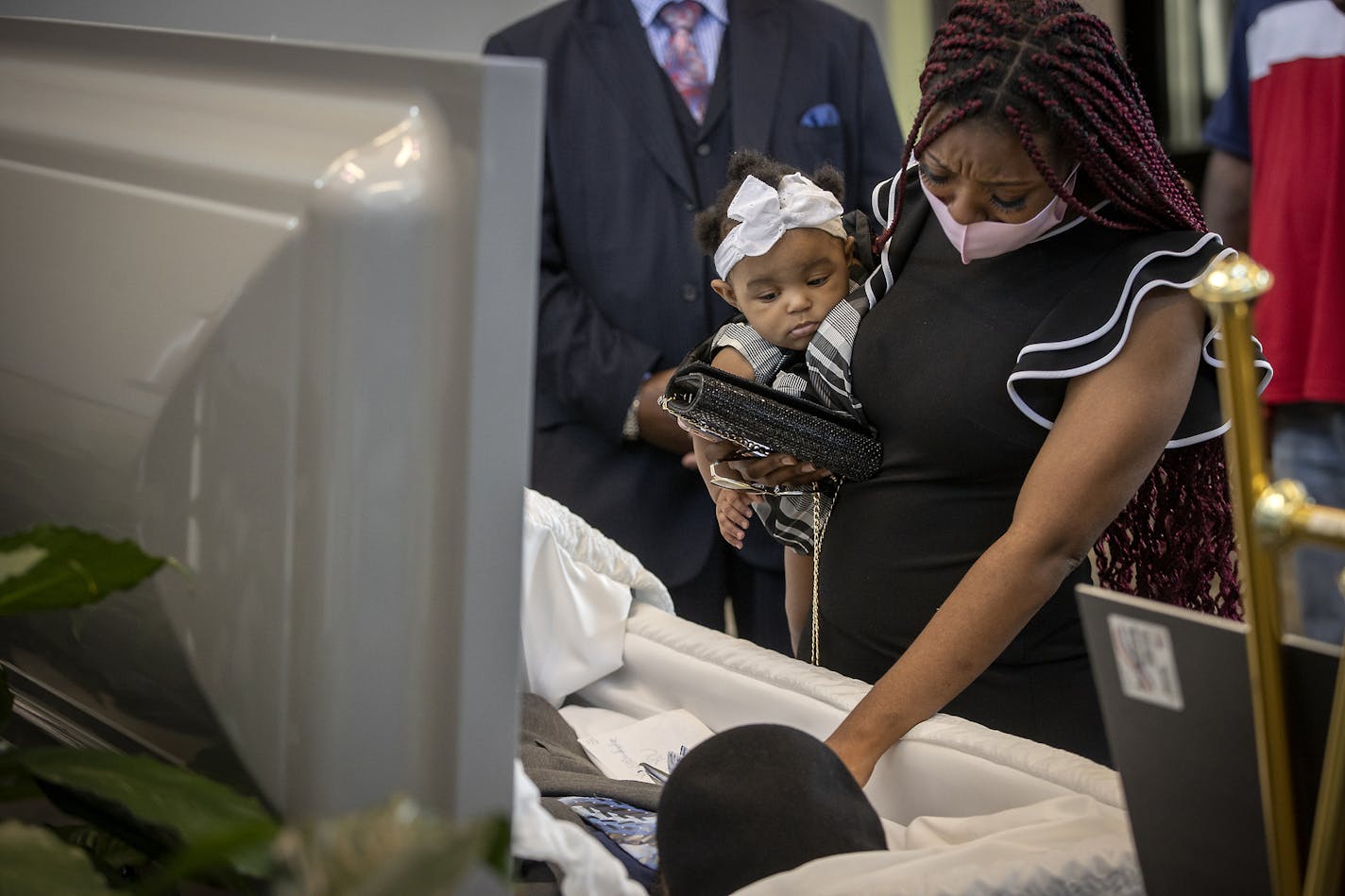 Mikayshia Horton, the daughter of Calvin L. Horton Jr. held his granddaughter Mi'kayah Horton as she said goodbye to him before the coffin was closed at his funeral at Estes Funeral Chapel, Friday, June 19, 2020 in Minneapolis, MN. Horton was shot and killed by John Richard Rieple, a pawn broker. Police found Horton lying on the sidewalk in front of the shop near Bloomington and Lake on the second night of civil unrest in the aftermath of the killing of George Floyd at the hands of Minneapolis p